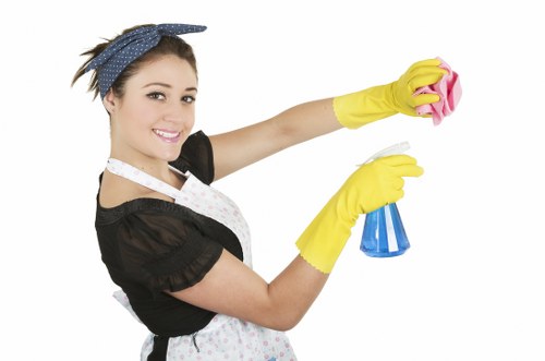 Staff member wearing PPE while handling cleaning materials